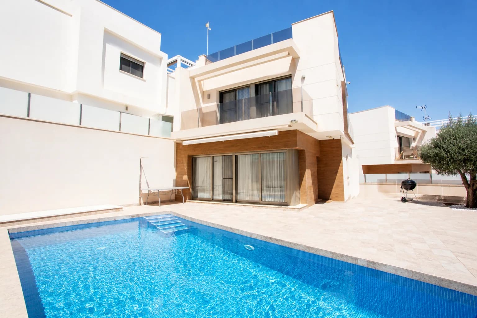 Private pool and villa exterior at Villa Duero in Villamartin